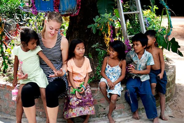 An AFSAI volunteer spending time with local children